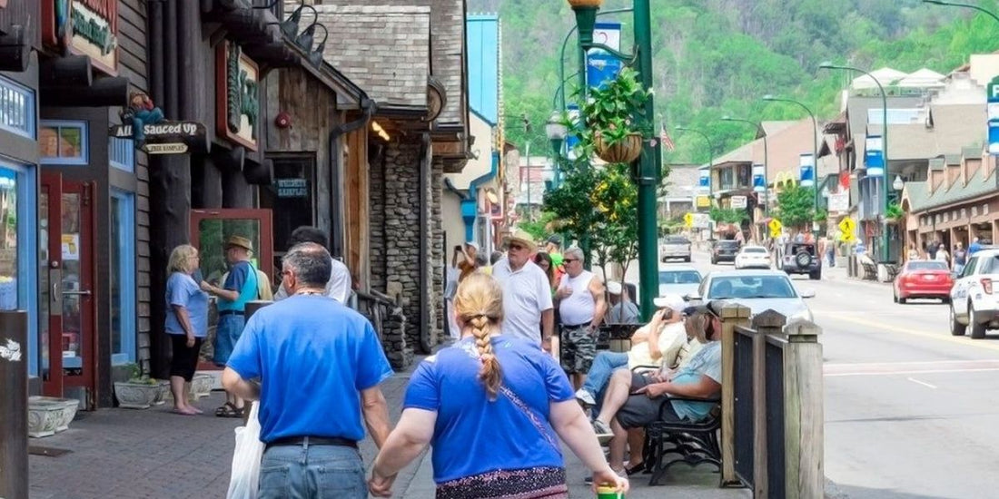 A couple walks hand in hand down the strip in Gatlinburg, TN