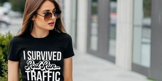 A woman poses with a t shirt that reads "I survived rod run traffic"